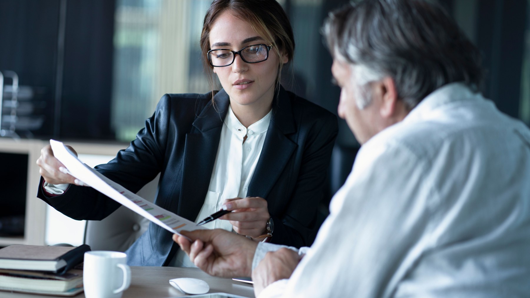 Advisers reviewing business financial records