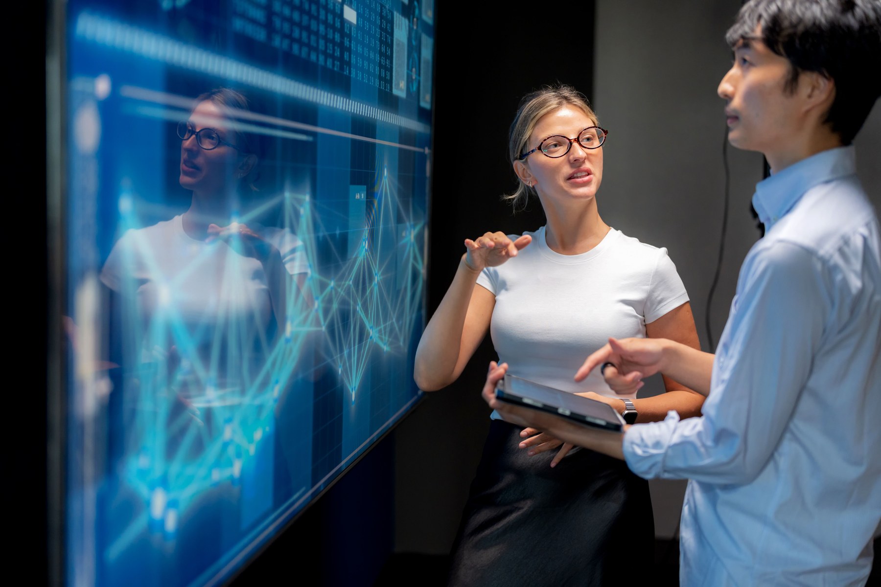 Professionals reviewing financial analysis on a presentation screen